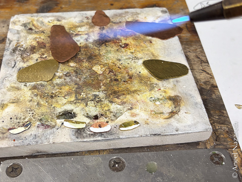 Solder applied to one edge of the various pieces